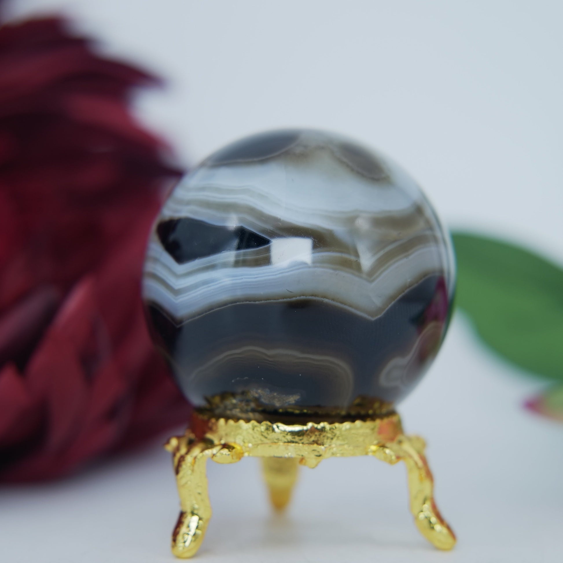 Polished Black and White Agate Sulemani Sphere 130g featuring banded patterns and glossy finish - Positive Faith Hope Love