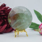 Polished Green Fluorite Sphere 630G 70Mm featuring banded green‑purple hues and glassy clarity - Positive Faith Hope Love