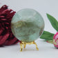 Polished Green Fluorite Sphere 630g 70mm featuring banded green‑purple hues and glassy clarity - Positive Faith Hope Love