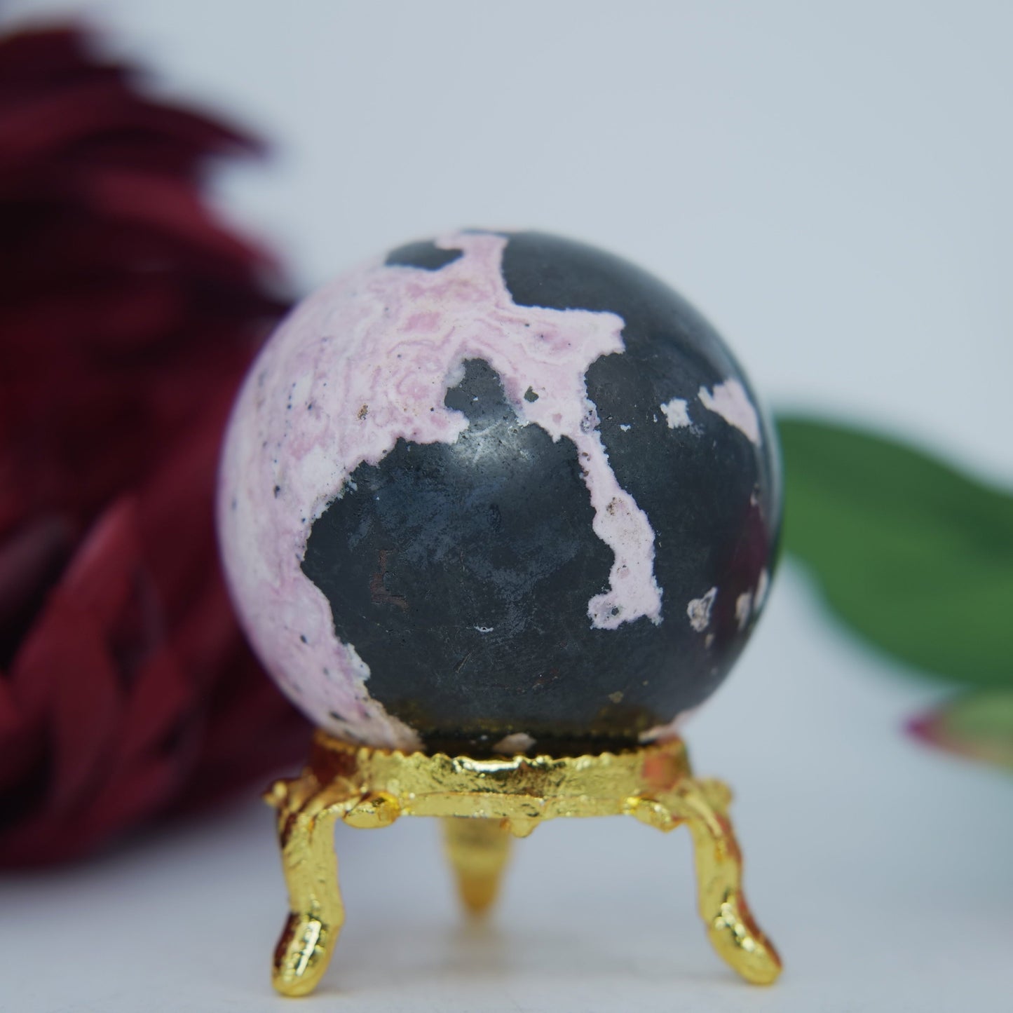 Polished Rhodochrosite Sphere 190G featuring pink bands and glassy finish - Positive Faith Hope Love