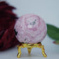 Polished Rhodochrosite Sphere 190G featuring pink bands and glassy finish - Positive Faith Hope Love