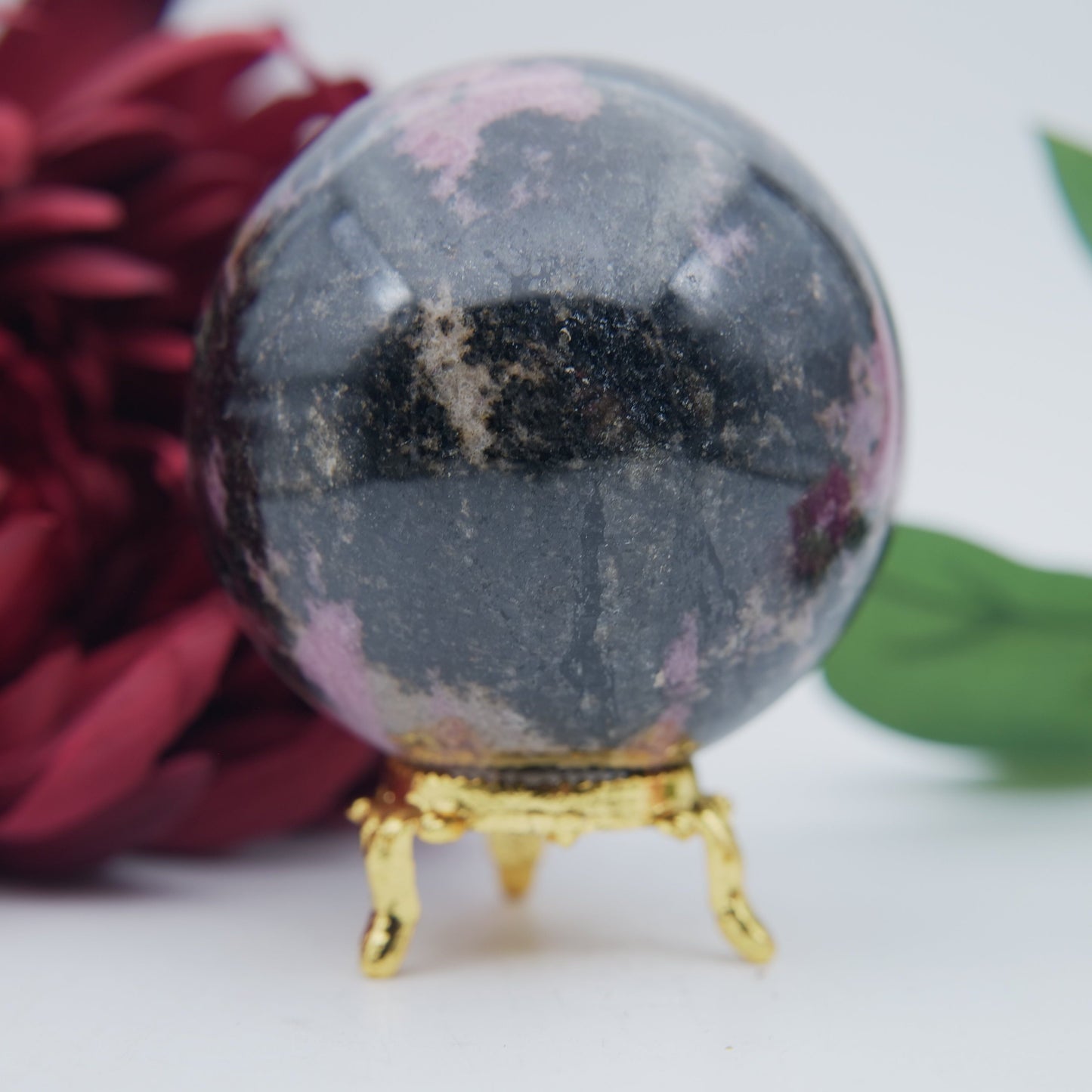 Polished Rhodonite Sphere Madagascar 693G featuring pink tone with black veining - Positive Faith Hope Love