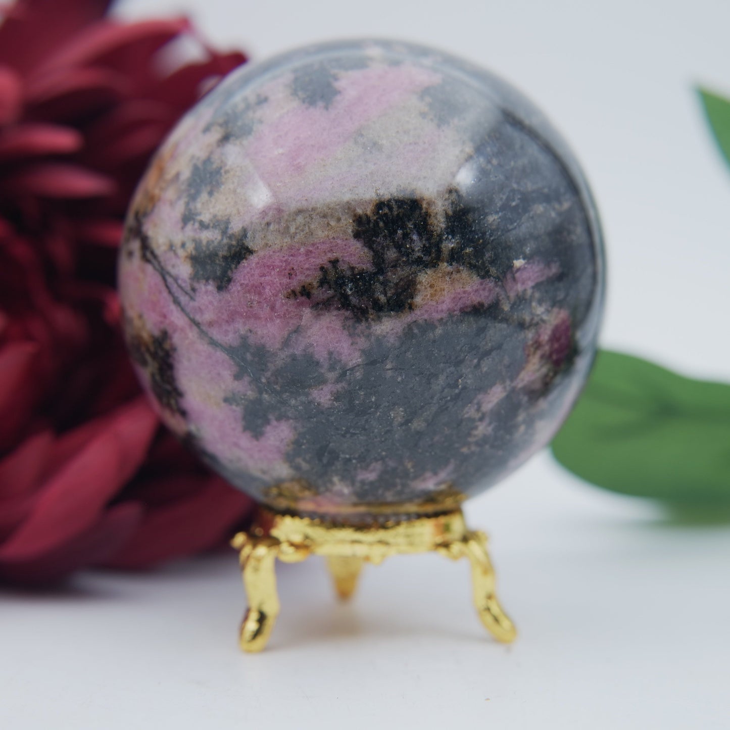Polished Rhodonite Sphere Madagascar 693G featuring pink tone with black veining - Positive Faith Hope Love