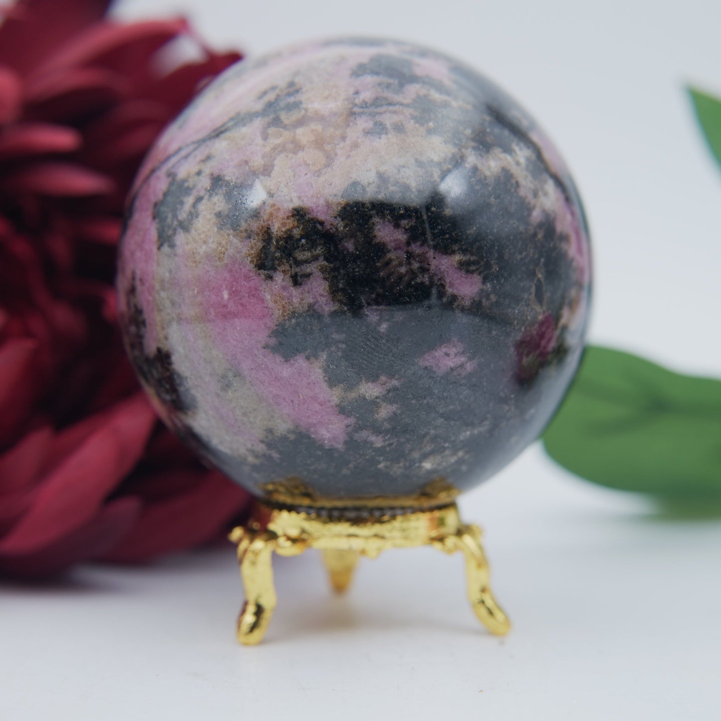 Polished Rhodonite Sphere Madagascar 693G featuring pink tone with black veining - Positive Faith Hope Love