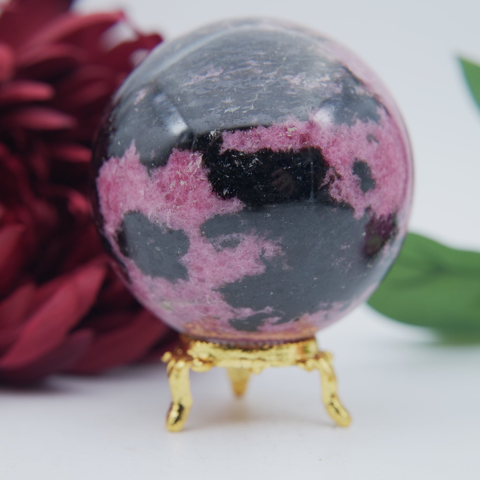 Polished Rhodonite Sphere Madagascar 712G featuring pink tone with black veining - Positive Faith Hope Love
