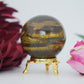 Polished Tigers Eye Sphere 215G 50Mm featuring chatoyant golden-brown bands - Positive Faith Hope Love